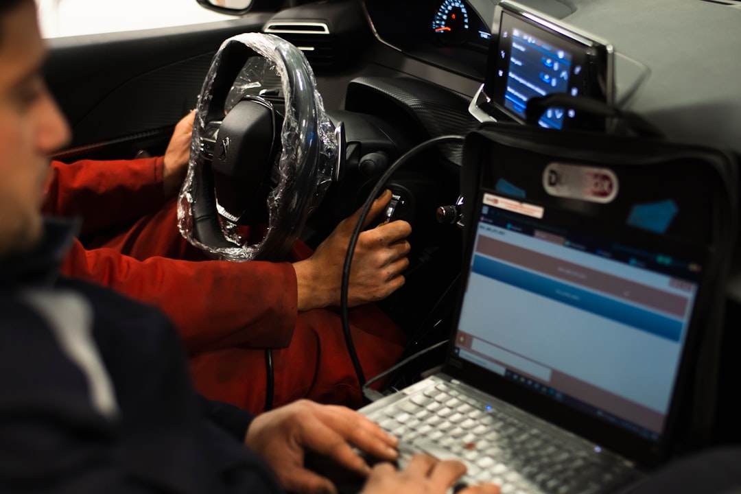 a-man-sitting-in-a-car-using-a-laptop-computer-dsoskr6g-w8