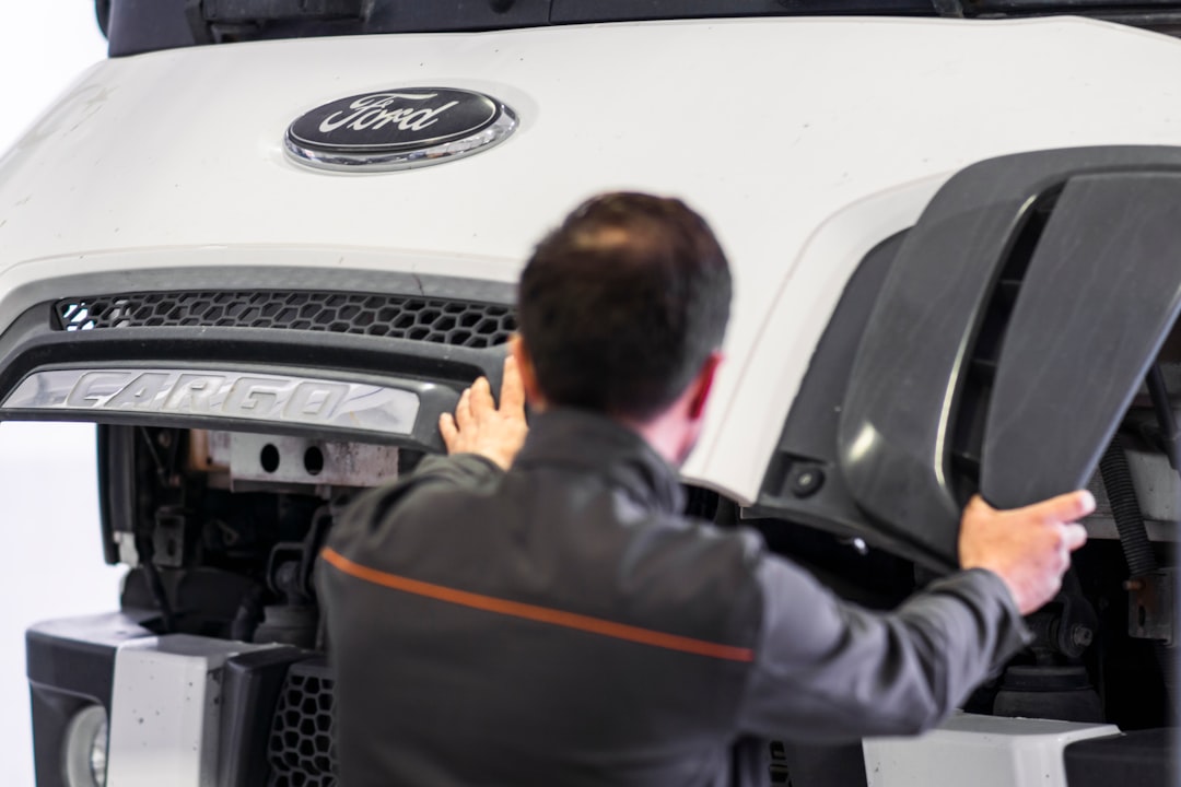 a-man-working-on-a-car-in-a-garage-rw9fz0tselk